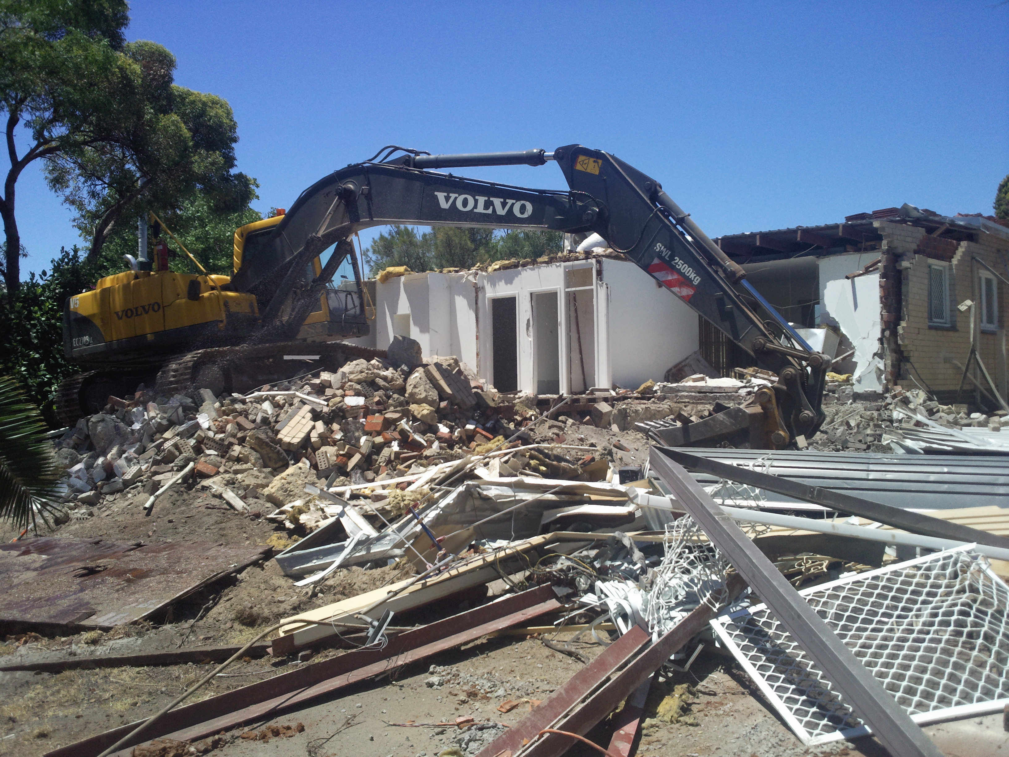 Volvo excavator carrying out residential demolition at 5 Banksia Circle, Thornlie